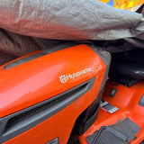 Husqvarna Gas-Powered Riding Lawn Tractor w/ Tow-Behind Spike/Plug Aerator Attachment (Orange)